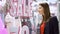 Beautiful attractive young woman standing near window shop. Sale sign. Female looking at window shop