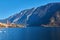 Beautiful autum landscape of Hallstatt mountain village with Hallstatter lake and boat in Austrian Alps.