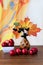 beautiful autumn bouquet of orange maple leaves, chokeberry and red apples on wooden table. Colorful nature.