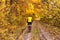 Beautiful autumn landscape - cycling through dirt path