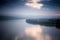 Beautiful autumn landscape, Danube river on a foggy cloudy day, clouds and sky are reflected in water