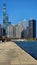 A beautiful autumn landscape at Lakefront Park with the rippling blue waters of Lake Michigan, autumn trees, people walking