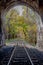 Beautiful autumn landscape from the tunnels. Railways and a tunnel lead directly into the forest