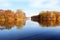 Beautiful autumn park. Autumn in Minsk. Autumn trees and leaves. Autumn Landscape.Park in Autumn. Mirror reflection of trees in wa