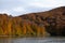 beautiful autumn passage changing season with trees reflected in the lake of Irabia Navarra Irati forest