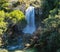 Beautiful autumn scene where a huge waterfall of water falls into the void of a canyon in the natural park of Ruidera lagoons