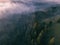 Beautiful autumn scenic panorama of foggy Carpathian mountains at early morning. Spruce forest.