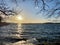 Beautiful autumn seascape sunset view with horizon, sky and sun reflections.