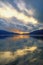 Beautiful autumn sunset. Montenegro, Bay of Kotor. Mountains and colorful clouds are reflected in water