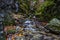 Beautiful autumn valley with waterfalls and green rocks