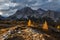 Beautiful autumn view Tofana di Rozes mountain with yellow larch trees on foreground. Dolomite Alps near Falzarego Pass.