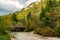 Beautiful autumn view of the Tschaminbach mountain stream in Weisslahnbad near Tiers, Italy