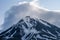 Beautiful autumn volcanic landscape - view of snow-capped cone of stratovolcano Bolshaya Udina Volcano in Klyuchevskaya