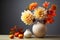 Beautiful autumnal bouquet with dahlia and pumpkin on table