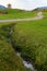 Beautiful autumnal scenery of tiny water flow going inside the field near Reichenbach, Allgaeu