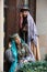 Beautiful azeri women in traditional Azerbaijani dress knocking the wooden door