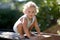 Beautiful baby boy in child garden posing photographer