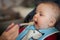 Beautiful baby boy eating porridge food