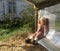 Beautiful baby in child sandpit posing photographer near sandbox