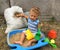 Beautiful baby in child sandpit posing photographer near sandbox