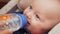 Beautiful baby drinking water from bottle