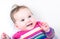 Beautiful baby girl in a knitted colorful dress on