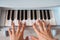 beautiful baby girl playing toy piano in light room