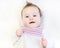 Beautiful baby girl in a warm knitted pink dress