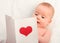 Beautiful baby and postcard Valentine\'s Day with a red heart