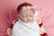 Beautiful baby reborn doll in flowers, professional newborn photoshoot