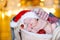 Beautiful baby in a Santa Claus hat sipping lying in a basket