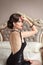 Beautiful back of elegant woman in black dress posing on mo