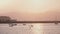 Beautiful background shot of romantic misty San Francisco sunset pier with boats and birds, sun reflecting in sea water.