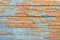 Beautiful background of worn wooden boards with blue and orange peeling paint