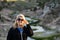 Beautiful backlit portrait of a blonde woman wearing casual clothing, fingers in her blonde hair. Taken at Hot Creek Mammoth Lakes