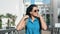 Beautiful backpacker travel girl in sunglasses walking outdoor at palm resort background