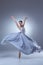 The beautiful ballerina dancing in blue long dress