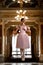 Beautiful ballerina dancing and jumping in a luxurious hall in a pink dress