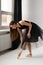 Beautiful ballerina dancing at studio in black dress, have training.