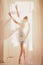 Beautiful ballerina girl with blond hair in ballet clothes and s