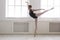 Beautiful ballerine stands in arabesque ballet position