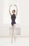 Beautiful ballerine stands in fifth ballet position