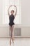 Beautiful ballerine stands in fifth ballet position