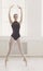 Beautiful ballerine stands in releve ballet position