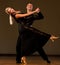 Beautiful ballroom couple preforms their exhibition dance