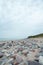 Beautiful baltic beach shoreside landscape view with rocks cloudy overcast weather.