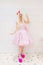 Beautiful barbie girl in white wig and pink dress. The image of a popular doll.