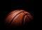 Beautiful basketball ball of orange color close-up on a dark background