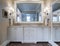 Beautiful bathroom interior with double sinks and marble counter, and large mirrors