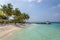 A beautiful bay inside a big resort in Maldives, green clear water with palm trees and blue sky